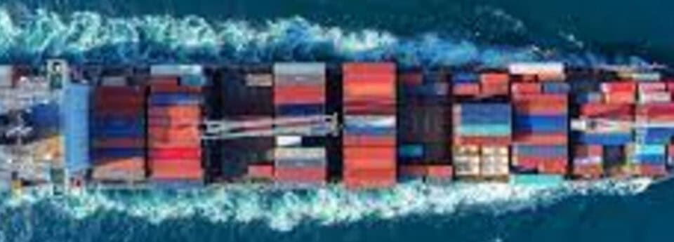 Container ship transporting freight across the ocean, cargo shipping logistics, maritime transportation, international trade, shipping containers.